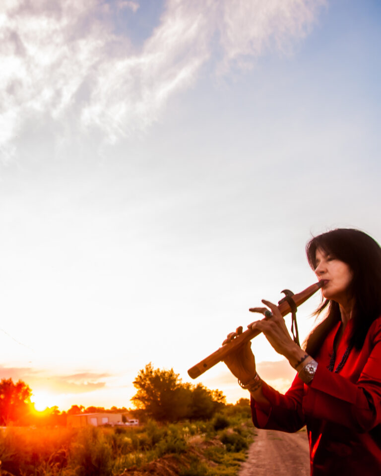 Joy Playing flute w horse -- Photo by Karen Kuehn